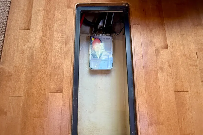 Slide: The Image of Storage compartment on a 2009 Sea Ray Sundancer 350 boat with wooden flooring. - 50