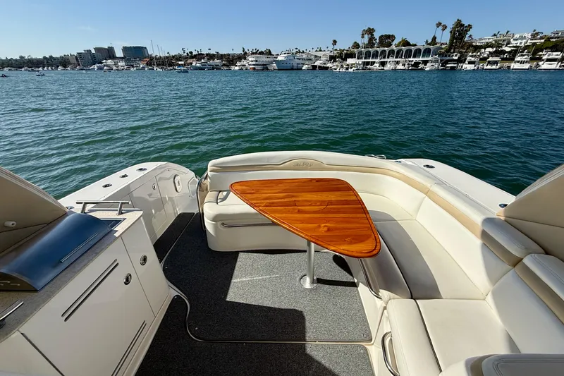 Slide: The Image of 2009 Sea Ray Sundancer 350 yacht interior with seating and table, overlooking marina. - 52