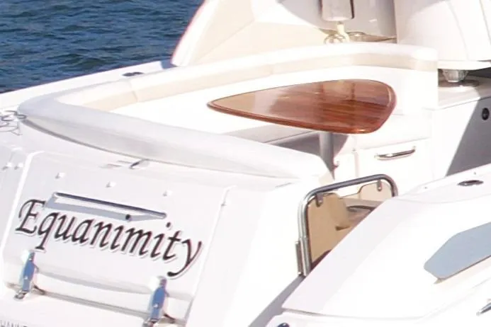 Slide: The Image of 2009 Sea Ray Sundancer 350 yacht named "Equanimity" with sleek design and wooden accents. - 54