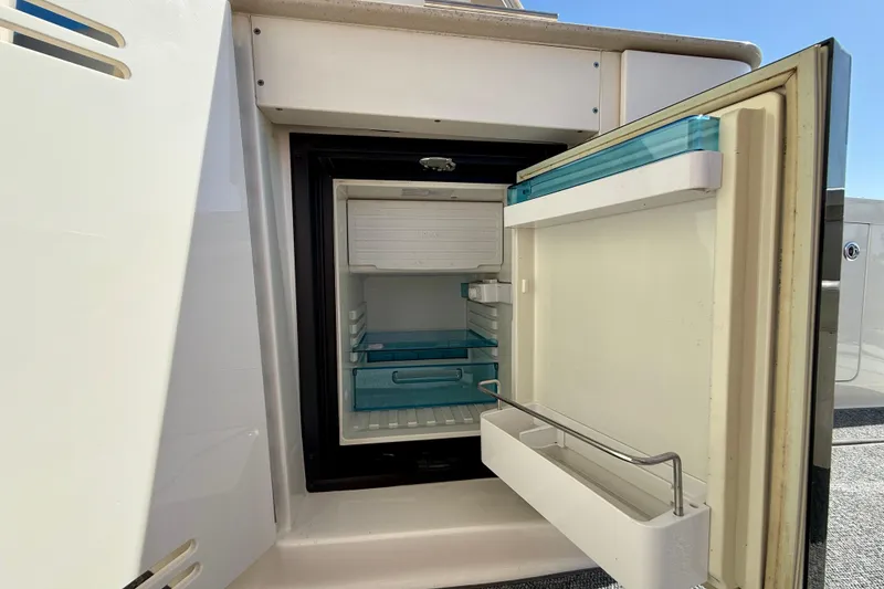 Slide: The Image of Open refrigerator on 2009 Sea Ray Sundancer 350 yacht, showcasing interior storage space. - 58