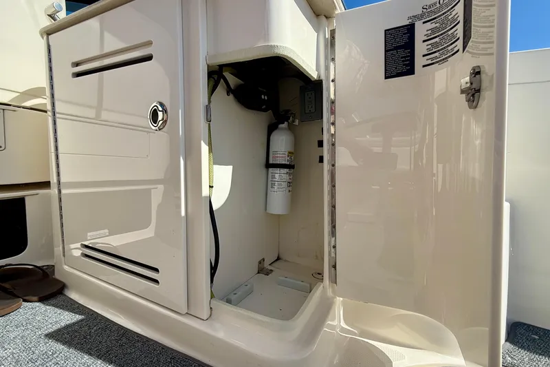 Slide: The Image of Open storage compartment on 2009 Sea Ray Sundancer 350 boat, revealing a fire extinguisher. - 59