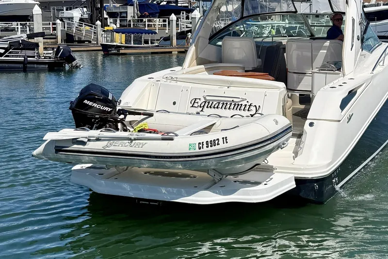 Slide: The Image of 2009 Sea Ray Sundancer 350 with dinghy and Mercury outboard motor at marina. - 6