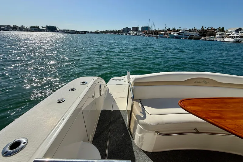 Slide: The Image of 2009 Sea Ray Sundancer 350 boat with seating area, overlooking a sunny marina. - 61