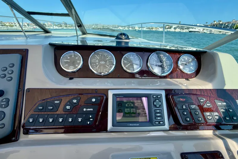 Slide: The Image of Dashboard of a 2009 Sea Ray Sundancer 350 boat with gauges and controls. - 64