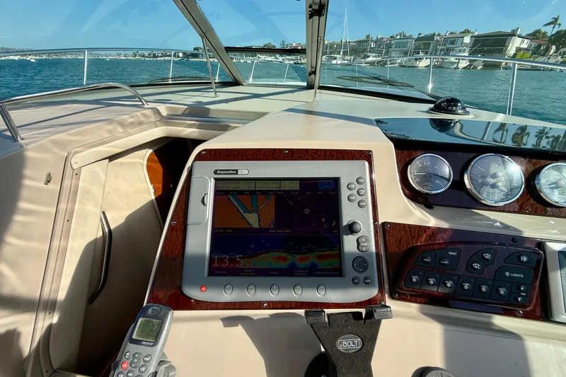 Slide: The Image of Cockpit view of a 2009 Sea Ray Sundancer 350 with navigation equipment and gauges. - 65
