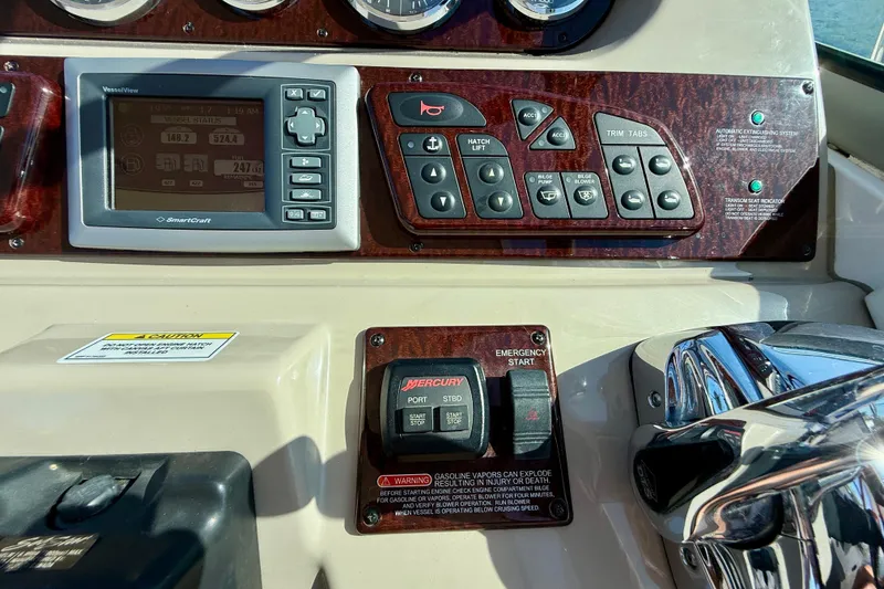 Slide: The Image of Control panel of a 2009 Sea Ray Sundancer 350 boat with navigation and engine controls. - 66