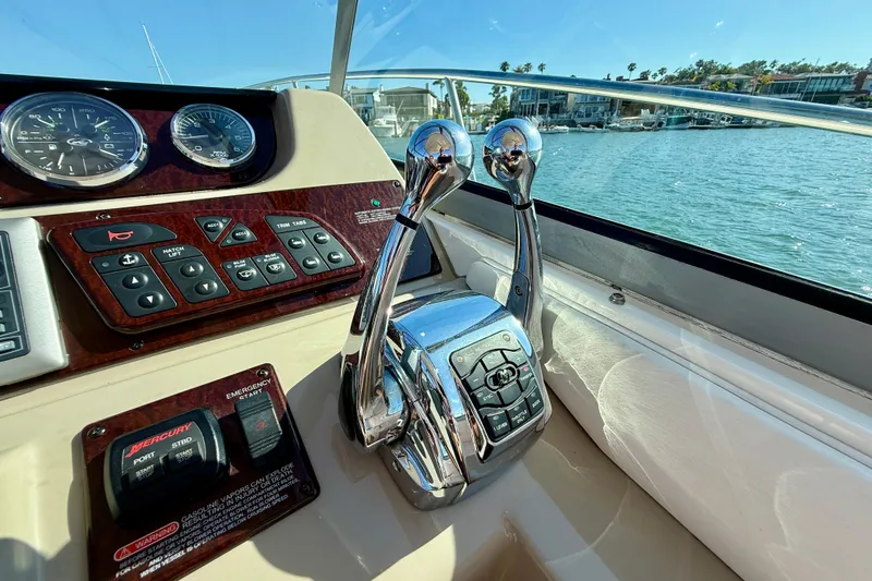 Slide: The Image of Control panel of a 2009 Sea Ray Sundancer 350 boat with throttle levers. - 67