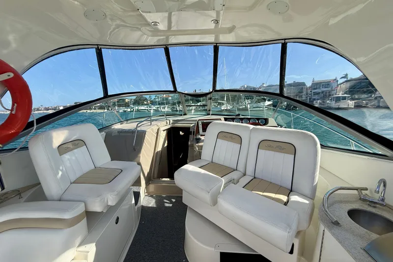 Slide: The Image of Interior view of 2009 Sea Ray Sundancer 350 yacht with white seating and ocean backdrop. - 74