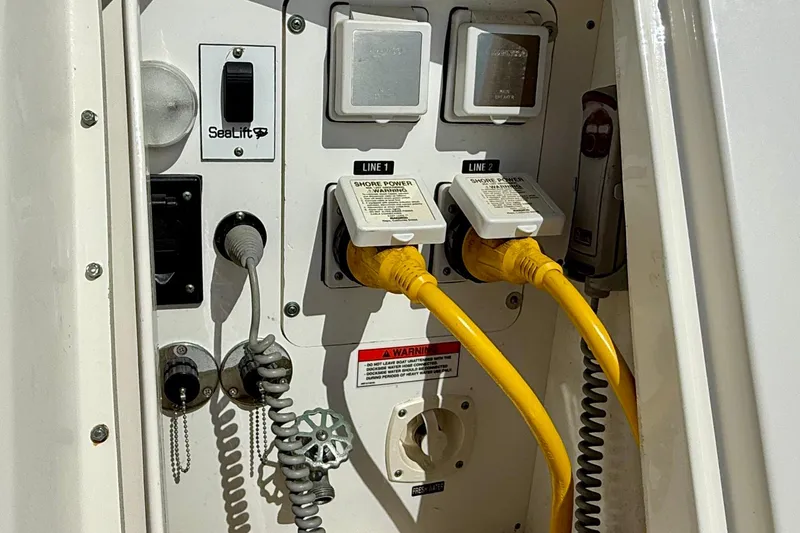 Slide: The Image of Electrical panel with yellow shore power cables on a 2009 Sea Ray Sundancer 350 boat. - 78