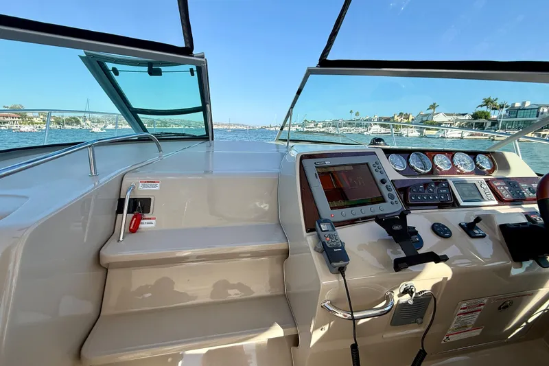 Slide: The Image of Cockpit view of a 2009 Sea Ray Sundancer 350, featuring navigation instruments and waterfront scenery. - 82