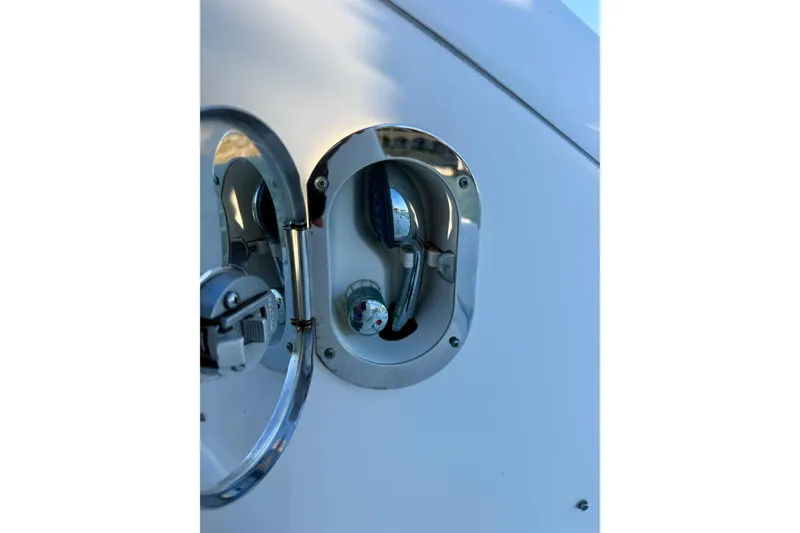 Slide: The Image of Fuel cap on a 2009 Sea Ray Sundancer 350 boat, featuring chrome detailing. - 87