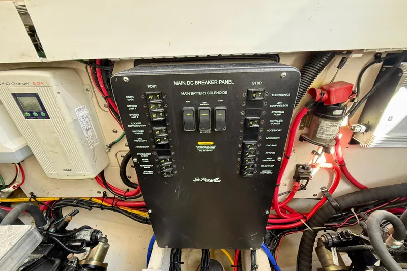 Slide: The Image of Main DC breaker panel on a 2009 Sea Ray Sundancer 350 boat, featuring various switches and wiring. - 90
