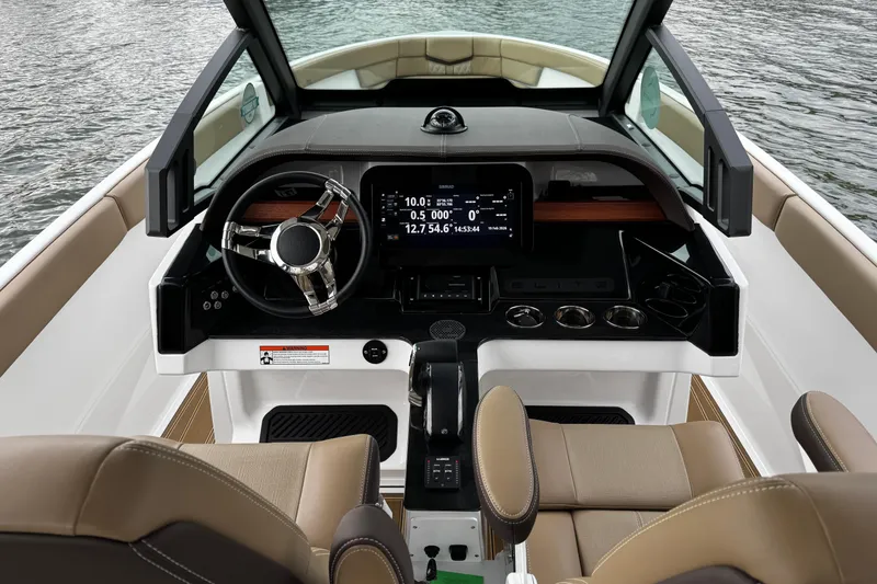 Slide: The Image of Cockpit of 2026 Monterey Elite 25 OB boat with modern steering and dashboard. - 13