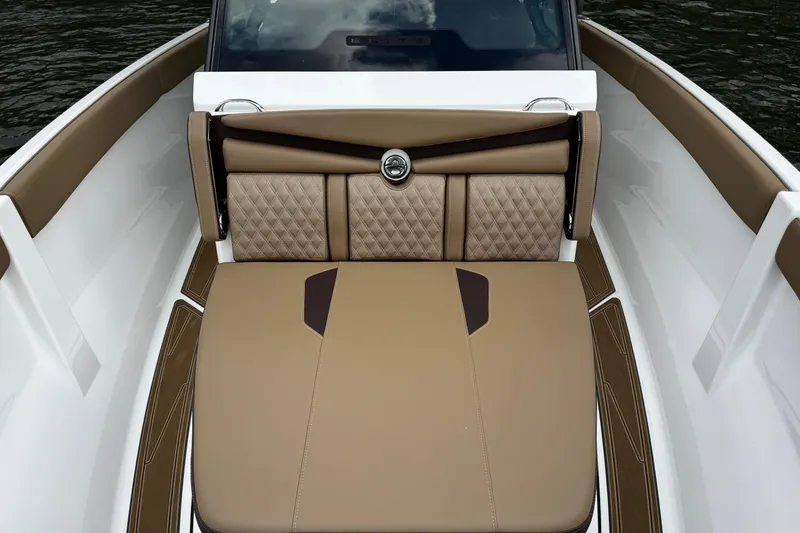 Slide: The Image of 2026 Monterey Elite 25 OB boat interior with luxurious tan seating and diamond stitching. - 15
