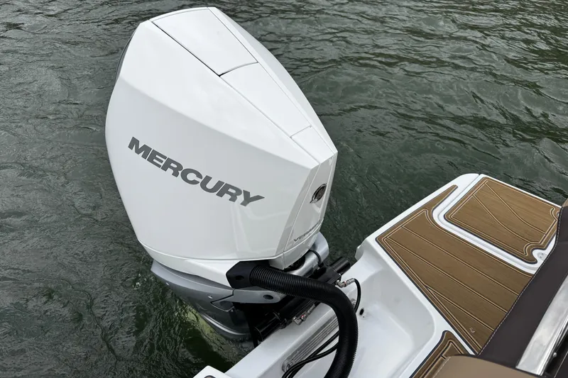 Slide: The Image of 2026 Monterey Elite 25 OB with Mercury outboard engine on water. - 19