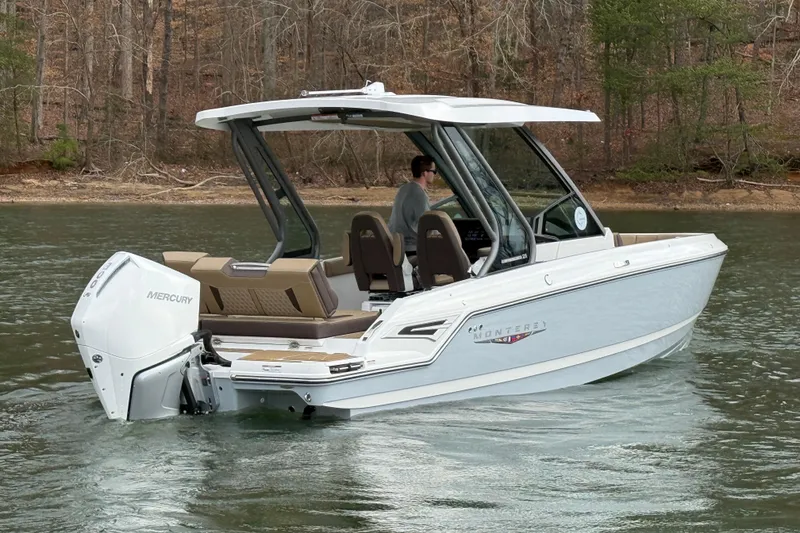Slide: The Image of 2026 Monterey Elite 25 OB boat cruising on a lake with Mercury outboard engine. - 3