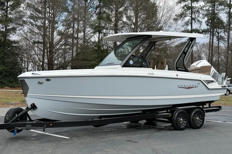 Slide: The Image of 2026 Monterey Elite 25 OB boat on trailer, parked outdoors. - 9