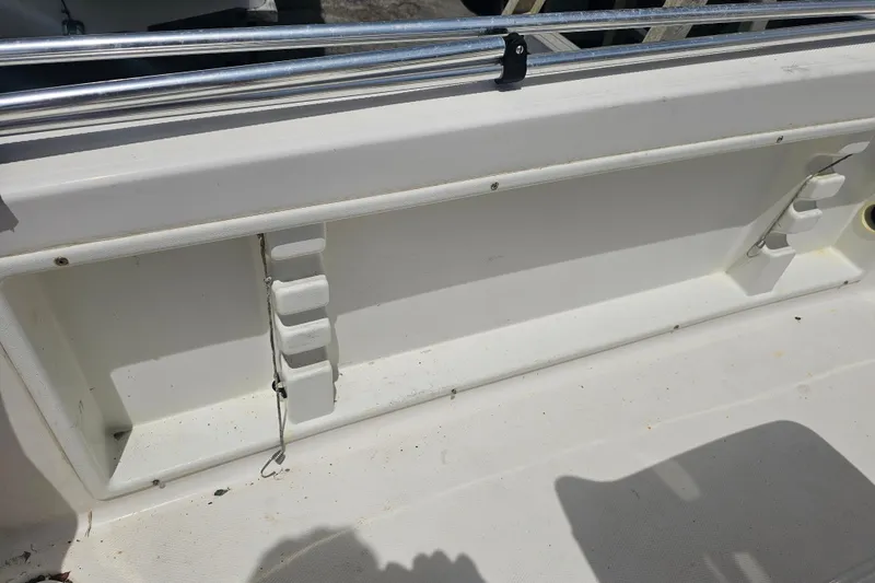 Slide: The Image of 1997 Wellcraft 190 CCF boat interior detail with storage compartment and railing. - 11