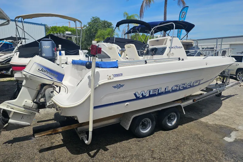 Slide: The Image of 1997 Wellcraft 190 CCF boat on trailer with Johnson outboard motor. - 2