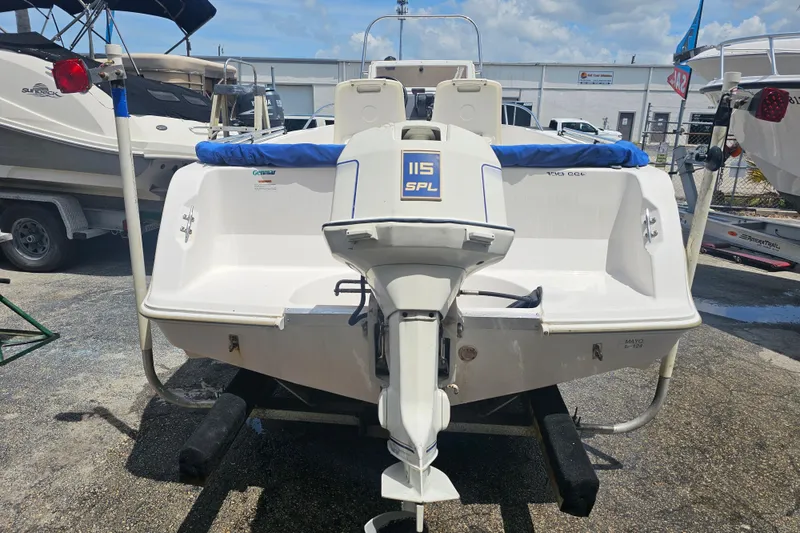 Slide: The Image of 1997 Wellcraft 190 CCF boat with 115 SPL outboard motor, parked outdoors. - 3