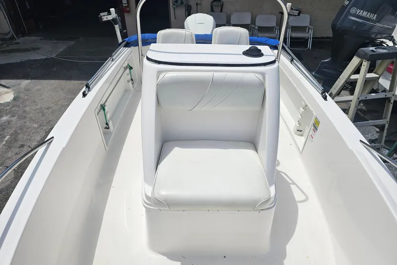 Slide: The Image of 1997 Wellcraft 190 CCF boat interior with white seating and Yamaha engine. - 6