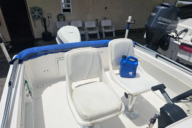 Slide: The Image of 1997 Wellcraft 190 CCF boat interior with Yamaha 150 engine and seating area. - 7