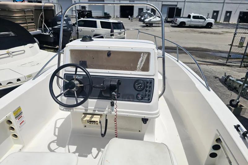 Slide: The Image of 1997 Wellcraft 190 CCF boat dashboard with steering wheel and controls. - 8