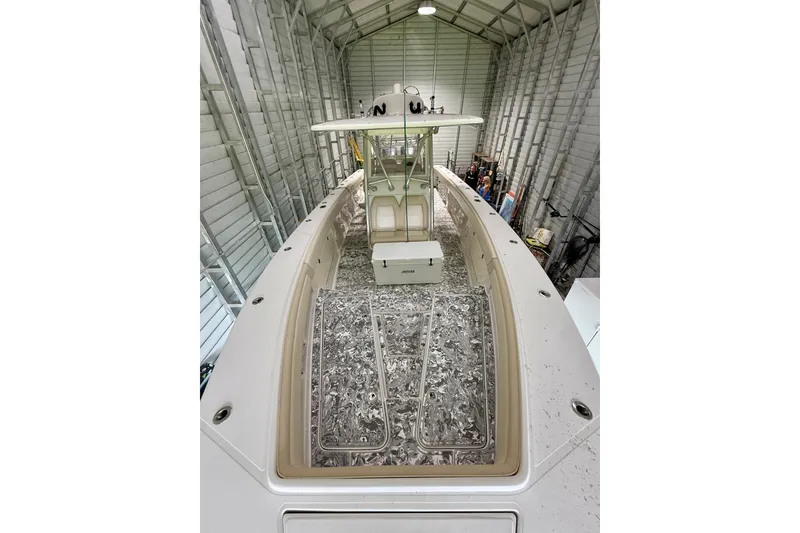 Slide: The Image of 2008 Jupiter 34 FS boat in storage, showcasing spacious deck and sleek design. - 11