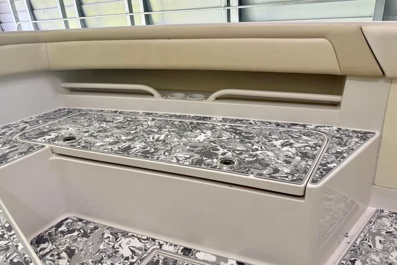 Slide: The Image of Interior view of a 2008 Jupiter 34 FS boat with patterned flooring and seating. - 14
