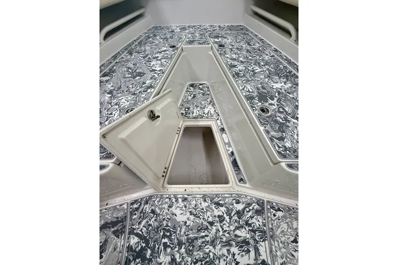 Slide: The Image of 2008 Jupiter 34 FS boat deck with open storage compartment, featuring marbled design. - 17