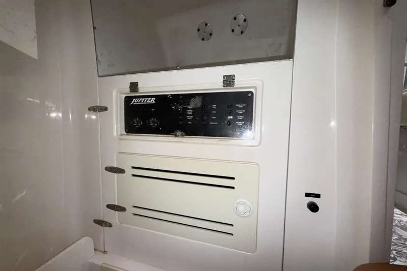 Slide: The Image of Control panel of a 2008 Jupiter 34 FS boat, featuring switches and vents. - 22