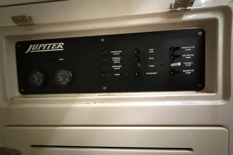 Slide: The Image of Control panel of a 2008 Jupiter 34 FS boat with various switches and gauges. - 24