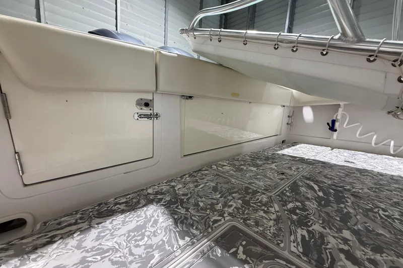 Slide: The Image of Interior view of a 2008 Jupiter 34 FS boat, showcasing storage compartments and patterned flooring. - 29