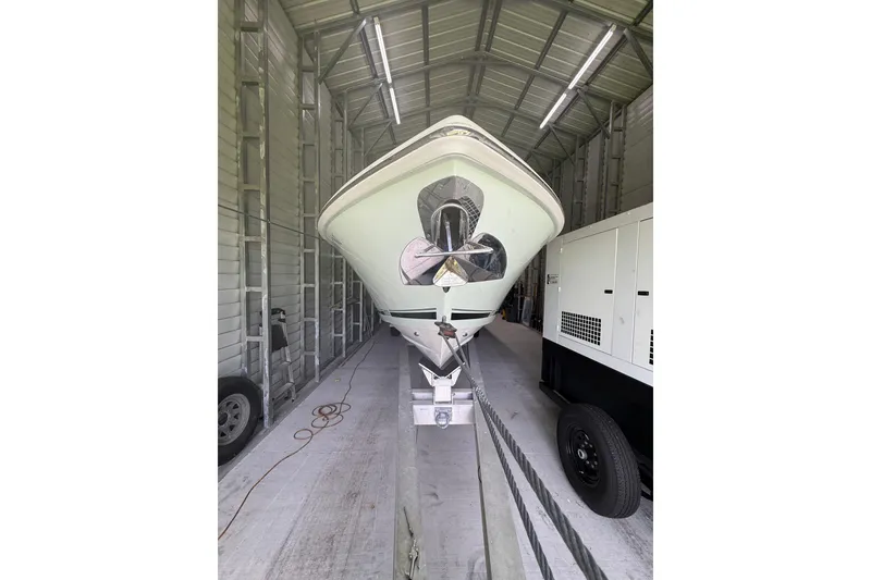 Slide: The Image of 2008 Jupiter 34 FS boat in storage, front view, inside a metal shed. - 32