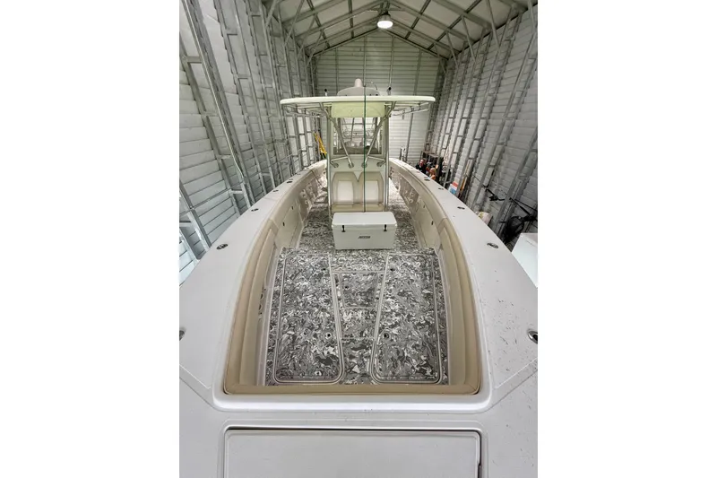 Slide: The Image of 2008 Jupiter 34 FS boat in storage, showcasing spacious deck and sleek design. - 35