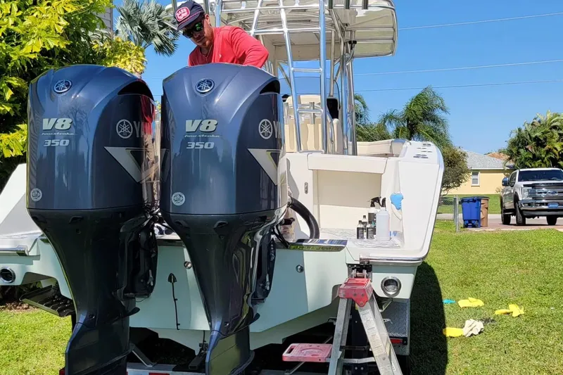 Slide: The Image of 2008 Jupiter 34 FS boat with twin Yamaha V8 350 engines, parked on grass. - 5