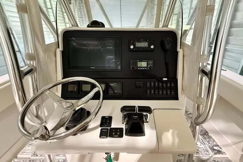 Slide: The Image of 2008 Jupiter 34 FS boat helm with steering wheel, controls, and navigation equipment. - 7