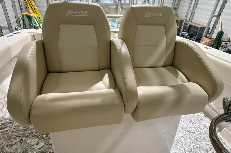 Slide: The Image of Beige leather seats on a 2008 Jupiter 34 FS boat, in a storage facility. - 9