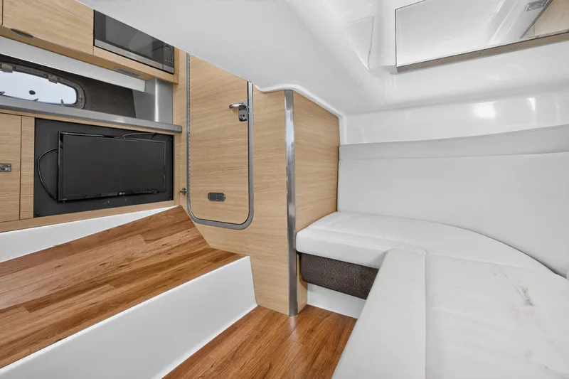 Slide: The Image of Interior of 2013 Chaparral 327 SSX boat with modern wood and white upholstery. - 39
