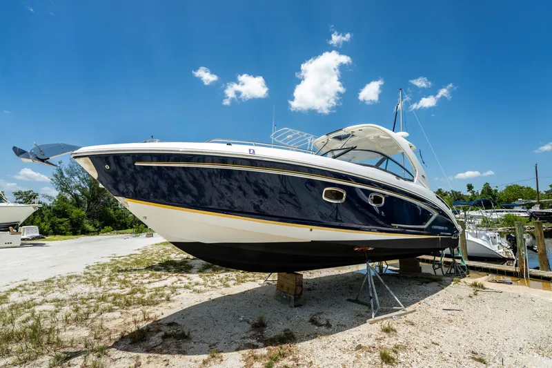 Slide: The Image of 2013 Chaparral 327 SSX boat on dry dock under clear blue sky. - 33