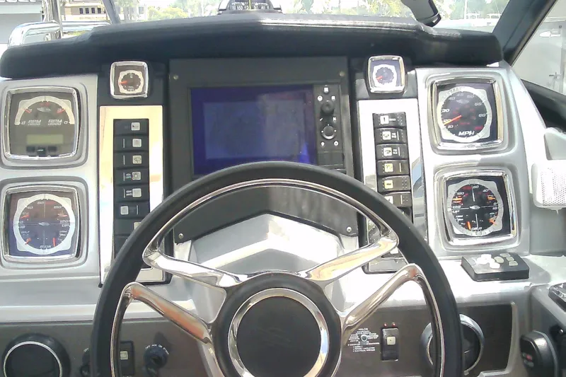 Slide: The Image of Dashboard of a 2013 Chaparral 327 SSX boat with steering wheel and gauges. - 12