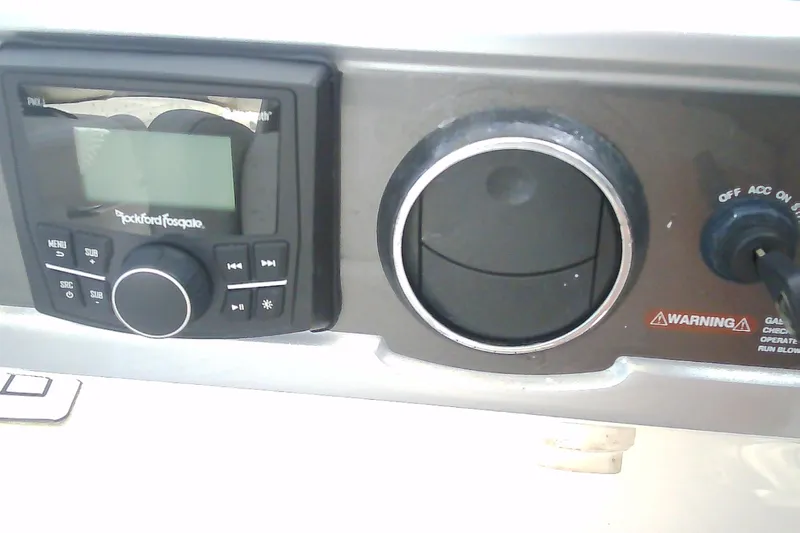 Slide: The Image of Control panel of a 2013 Chaparral 327 SSX boat featuring Rockford Fosgate audio system. - 13