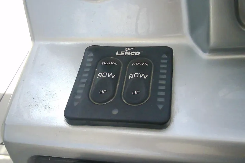 Slide: The Image of Lenco trim tab control panel on 2013 Chaparral 327 SSX boat dashboard. - 14