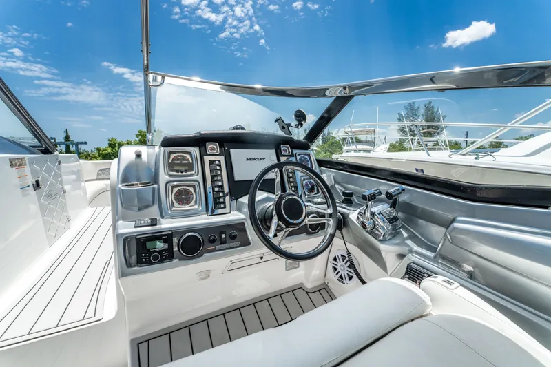 Slide: The Image of Interior view of 2013 Chaparral 327 SSX boat cockpit with modern controls and steering wheel. - 52