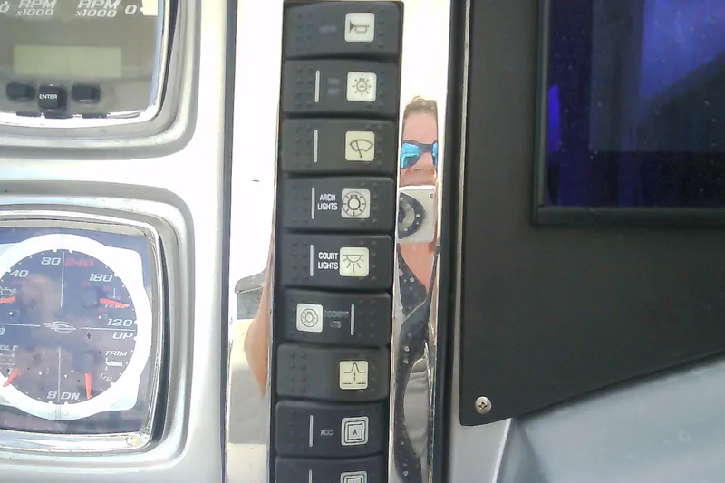 Slide: The Image of Dashboard controls and gauges of a 2013 Chaparral 327 SSX boat. - 15