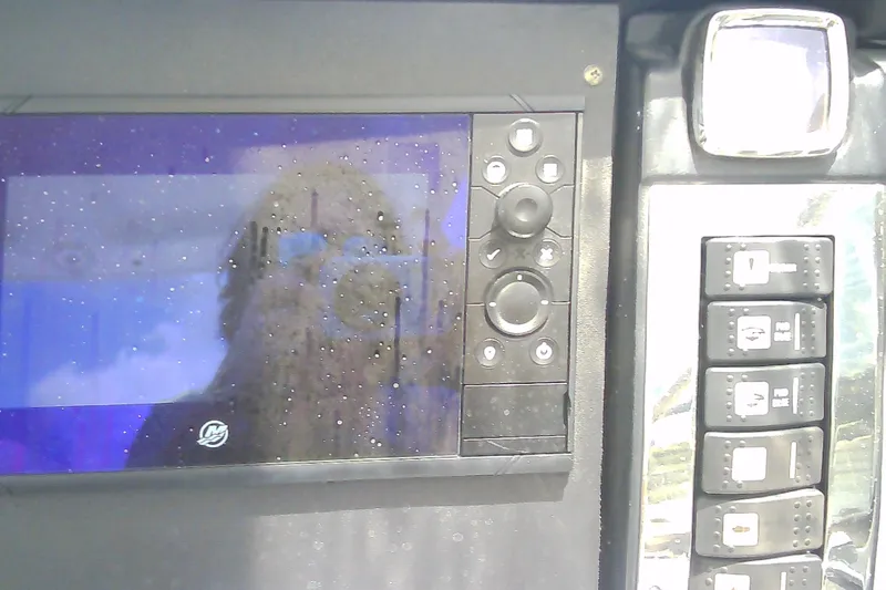 Slide: The Image of Control panel of a 2013 Chaparral 327 SSX boat with display and buttons. - 16