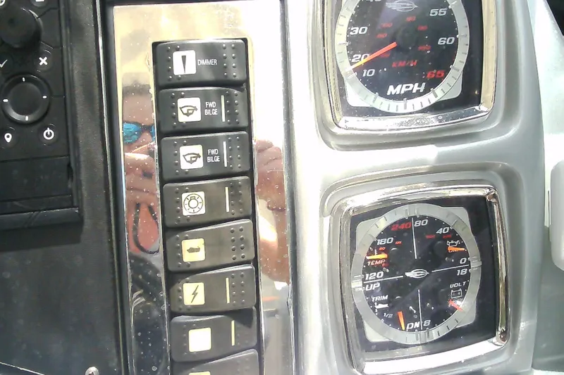 Slide: The Image of Dashboard controls and gauges of a 2013 Chaparral 327 SSX boat. - 17