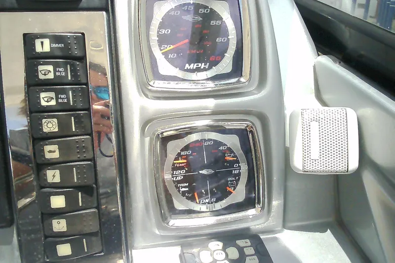 Slide: The Image of Dashboard of a 2013 Chaparral 327 SSX boat with gauges and control buttons. - 18