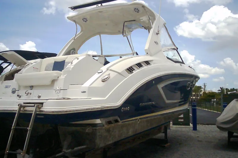 Slide: The Image of 2013 Chaparral 327 SSX boat on display under a cloudy sky. - 2