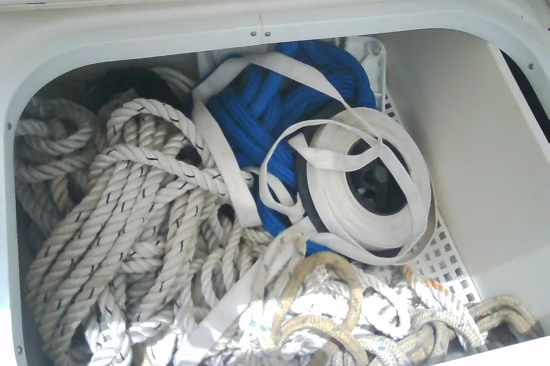 Slide: The Image of Storage compartment with ropes and straps on a 2013 Chaparral 327 SSX boat. - 22